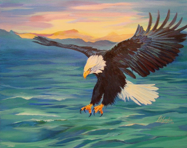 Bald Eagle flying over the ocean at sunset.